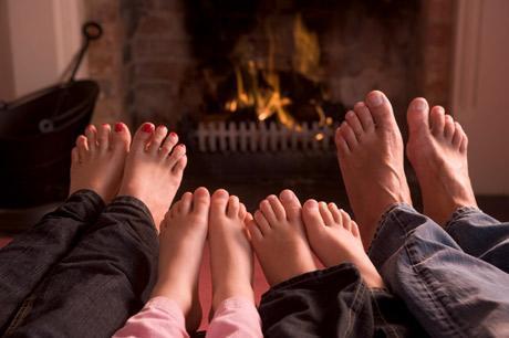 four family feet by fireplace